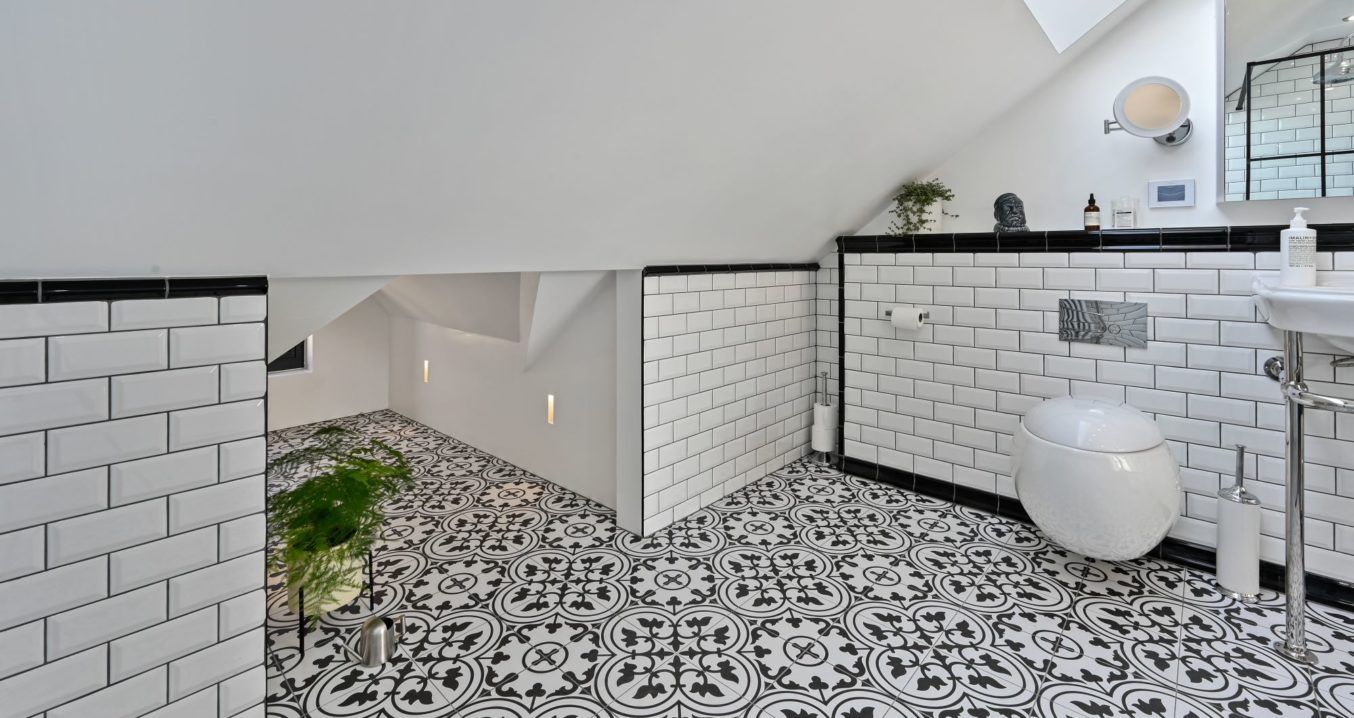 Tiled black and white bathroom of a hip to gable loft conversion in Clapham SW London