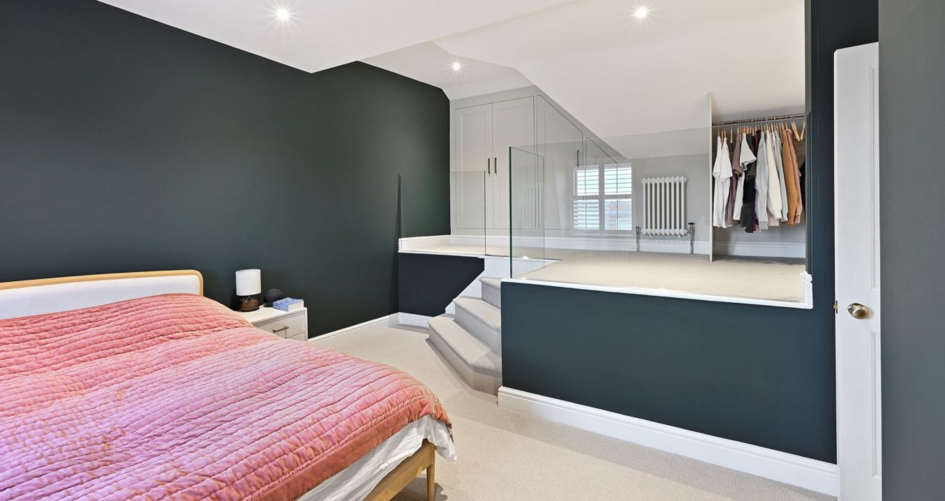 Abbeywood SE2 Mansard loft conversion showing primary bedroom with king size bed and dressing room.